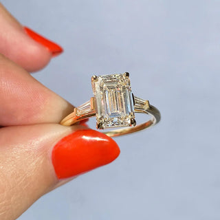 Graceful 1.91ct emerald three stone moissanite ring tilted view catching the light