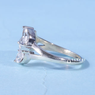 Front standing view of the Three Stone Marquise Moissanite Emerald Cut Engagement Ring showing the prong setting
