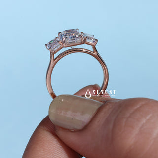 Brilliant 2.0ct emerald three stone moissanite ring shown on a finger