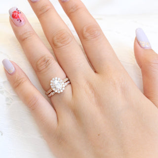 Luminous 1.50ct oval halo moissanite ring shown on a finger