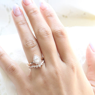 Elegant 1.0ct pear halo moissanite ring shown on a finger