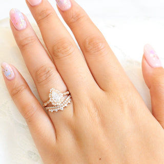 Delicate 1.0ct pear halo moissanite ring shown on a finger