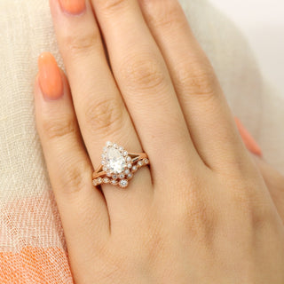 Timeless 1.50ct pear halo moissanite ring shown on a finger