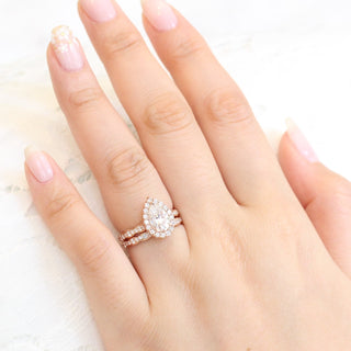 Exquisite 1.50ct pear halo moissanite ring shown on a finger