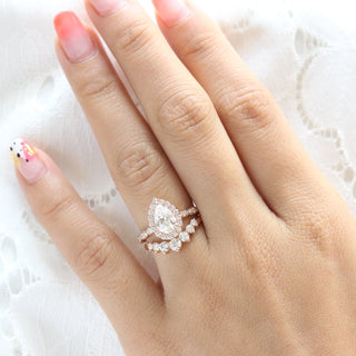 Brilliant 1.60ct pear halo moissanite ring shown on a finger