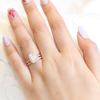 Brilliant 1.60ct emerald halo moissanite ring shown on a finger