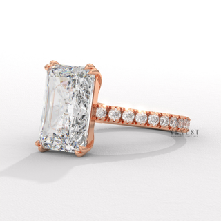 Front view of a radiant cut moissanite engagement ring with a pave band with the band in focus