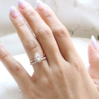 Radiant 1.0ct pear halo moissanite ring shown on a finger