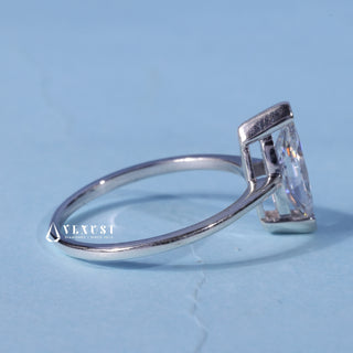 Solitaire Marquise Cut Moissanite Engagement Ring resting on its side showing the slim band