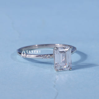 Moissanite Emerald Cut Engagement Ring resting on its side showing the slim band