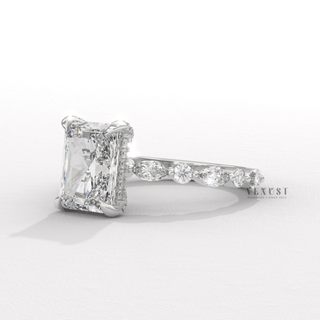 Front view of a round cut moissanite engagement ring with a hidden halo and pave band with the stone in focus
