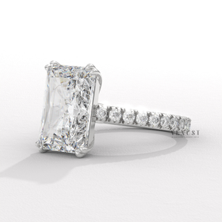 Front view of a radiant cut moissanite engagement ring with a pave band with the stone in focus