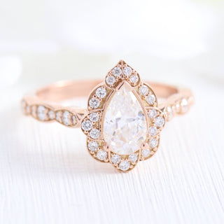 Refined 1.0ct pear halo moissanite ring three quarter angled view