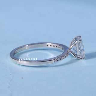 Pave Radiant Cut Moissanite Engagement Ring resting on its side showing the slim band
