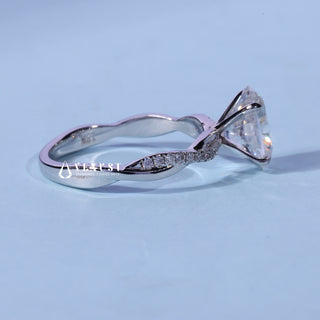 Oval Cut Pave Infinity Moissanite Engagement Ring resting on its side showing the slim band