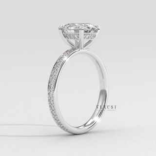 Tilted view of a oval cut moissanite engagement ring with a hidden halo and pave band showing its sparkle