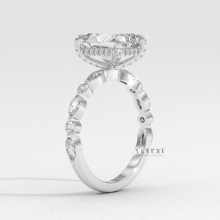Side profile of a round cut moissanite engagement ring with a hidden halo and pave band under soft light