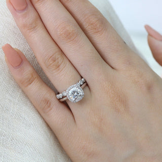 Delicate 2.30ct cushion halo moissanite ring tilted view catching the light