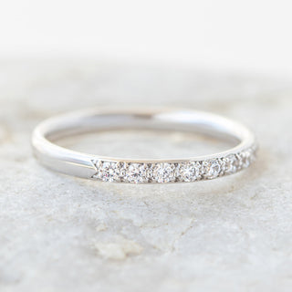 Modern round half eternity moissanite wedding band sparkle close up