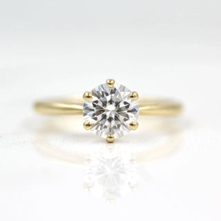 Luminous 1.0ct round solitaire moissanite ring angled view showing its sparkle