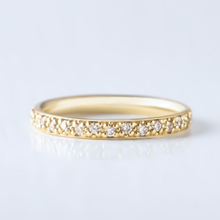 Refined round half eternity moissanite wedding band angled view showing its sparkle image 2