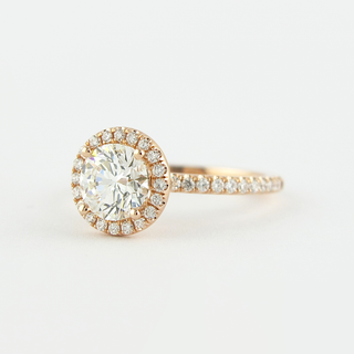 Modern 1.0ct round halo moissanite ring angled view showing its sparkle