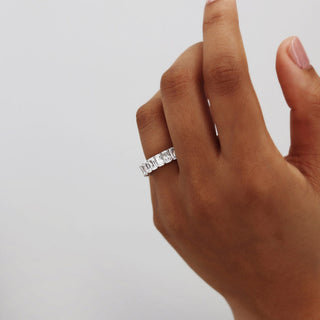 Delicate 6.0ct emerald full eternity moissanite wedding band angled view showing its sparkle