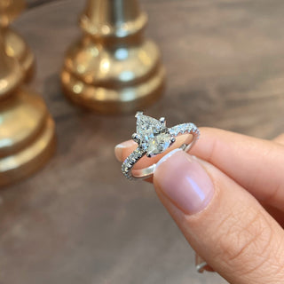 Delicate 1.5ct pear hidden halo moissanite ring top view