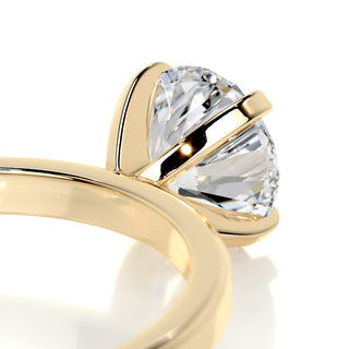 Refined 1.0ct round solitaire moissanite ring angled view showing its sparkle