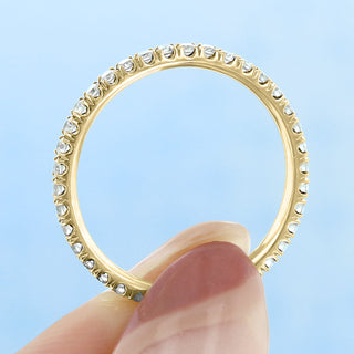 Bold round full eternity moissanite wedding band close up of the setting