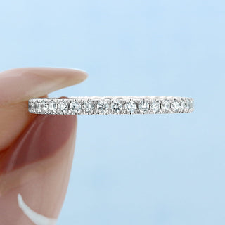 Modern round full eternity moissanite wedding band close up of the setting