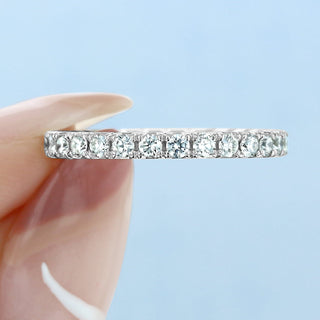 Refined round full eternity moissanite wedding band close up of the setting