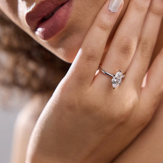 Shimmering 1.0ct marquise solitaire moissanite ring tilted view catching the light