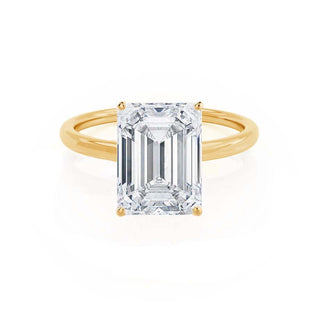 Delicate 1.01ct emerald solitaire moissanite ring angled view showing its sparkle