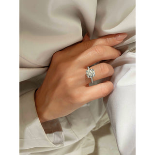 Timeless 1.0ct round pave moissanite ring shown on a finger