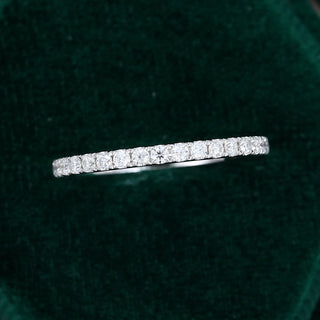 Classic 0.25ct round half eternity moissanite wedding band shown on a finger