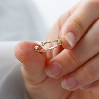 Graceful round half eternity moissanite wedding band detail view of the band image 2