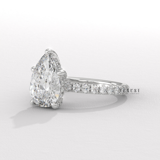 Side profile of a pear cut moissanite engagement ring with a pave band