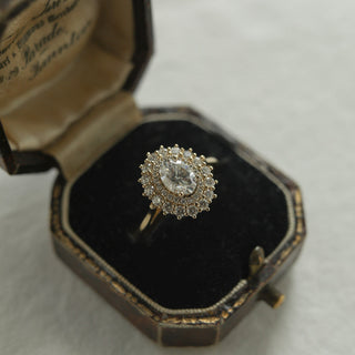 Stunning 0.75ct oval halo moissanite ring shown on a finger