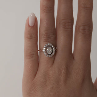 Classic 0.75ct oval halo moissanite ring angled view showing its sparkle