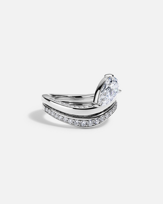 Brilliant 2.0ct pear pave moissanite wedding band shown on a finger