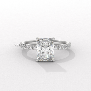 Overhead close-up of a radiant cut moissanite engagement ring with a hidden halo and pave band