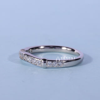 Lustrous round moissanite wedding band angled view showing its sparkle