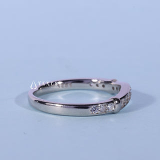Lustrous round moissanite wedding band close up of the setting