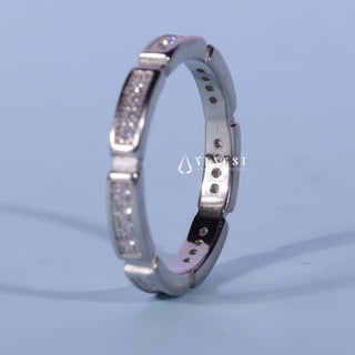 Luminous round pave moissanite wedding band shown on a finger