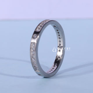 Sparkling round pave moissanite wedding band shown on a finger