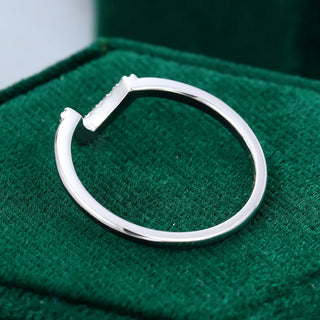 Sparkling 0.09ct round moissanite wedding band shown on a finger