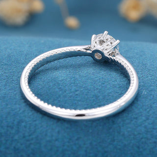 Shimmering 0.41ct round solitaire moissanite ring shown on a finger