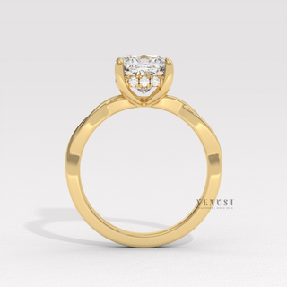 Top-down view of a cushion cut moissanite engagement ring on an infinity band