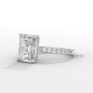 Macro shot of the centre stone on a radiant cut moissanite engagement ring with a hidden halo and pave band